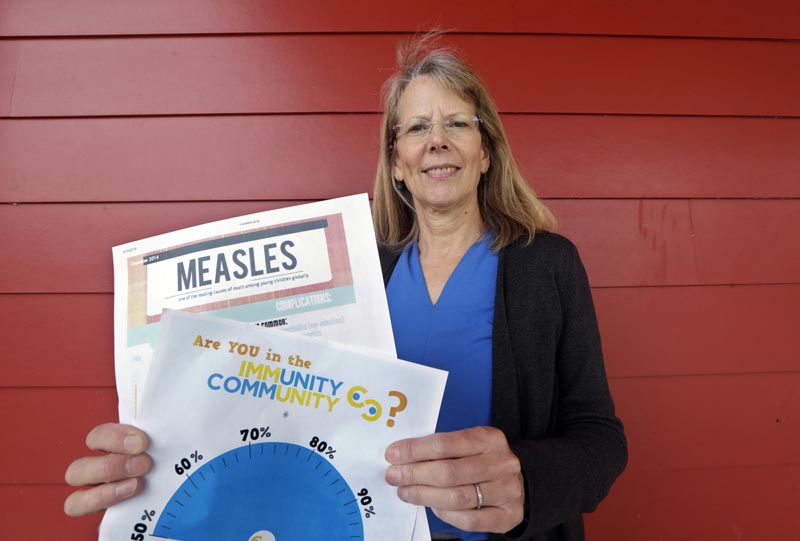 In this photo taken Wednesday, May 15, 2019, Vashon Island High School nurse Sarah Day holds information about measles vaccinations as she poses for a photo in Vashon Island, Washington. Photo: AP