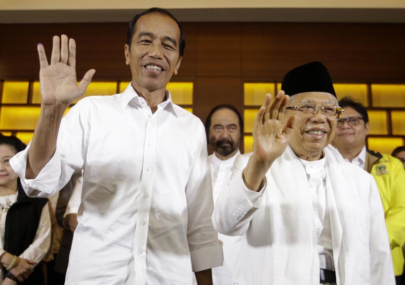 FILE: In this April 17, 2019, file photo, Indonesian President Joko Widodo (left) and his running mate Ma'ruf Amin wave to journalists after a press conference in Jakarta, Indonesia. Photo: AP/file