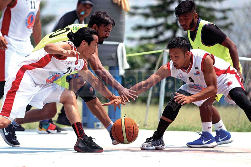 Bijay Burja (left) and Sadhish Pradhan of Times International Club vie for the ball against Mohamedul Hasan and Sandesh Tamang of Nepal Police Club during their Kwiks Nepal Basketball League match at Dhubarahi in Kathmandu on Tuesday. Photo: Udipt Singh Chhetry/ THT