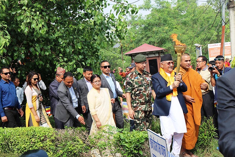 Prime Minister KP Sharma Oli his spouse Radhika Shakya among other officials holds flame take part in a rally organised by the government of Province 5 on the occasion of 2,563rd Buddha Jayanti and the beginning of Visit Lumbini Year 2076 BS, in Lumbini, on Saturday, May 18, 2019. Photo: RSS