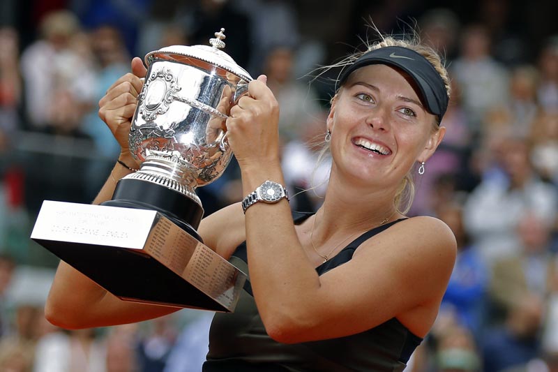 FILE - In this Saturday June 9, 2012 file photo, Maria Sharapova of Russia holds the trophy after winning the women's final match against Sara Errani of Italy at the French Open tennis tournament in Roland Garros stadium in Paris. Two-time French Open champion Maria Sharapova has pulled out of the yearu0092s second Grand Slam tournament because of her injured right shoulder. Sharapova announced her withdrawal on Instagram, on Tuesday, May 14, 2019. (AP Photo/Michel Euler, File)