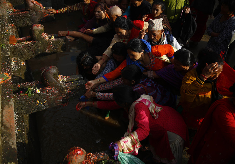 Devotees collect holy water from stone taps in memory of their deceased mothers on Mother's Day at Matatirtha pond, a pilgrimage site in Kathmandu, on Saturday, May 04, 2019. It is believed that those who take a holy dip in remembrance of their deceased mothers at Matatirtha helps his/her mother reach salvation and bring prosperity to the family. Photo: Skanda Gautam/THT