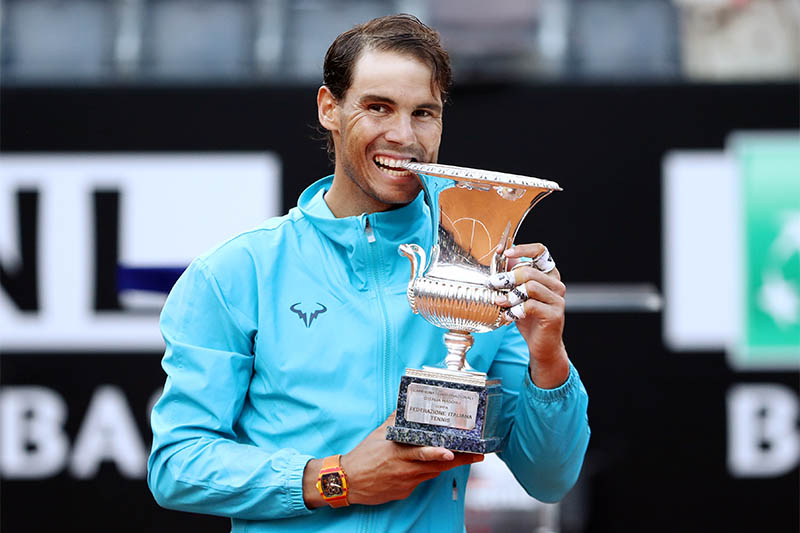 Spain's Rafael Nadal poses as he celebrates winning the final against Serbia's Novak Djokovic with the trophy. Photo: Reuters