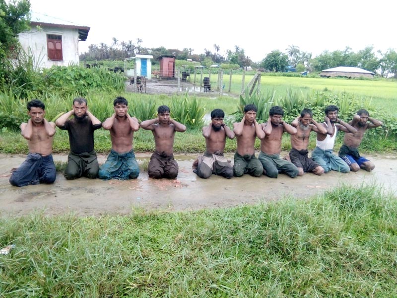 Ten Rohingya Muslim men with their hands bound kneel in Inn Din village, Myanmar, September 1, 2017. Photo: Handout via Reuters