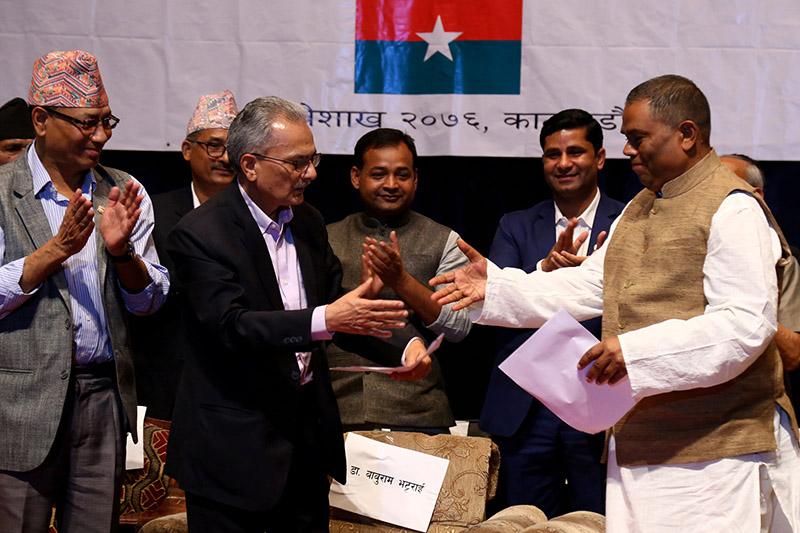 Party president of FSFN, also the Deputy Prime Minister and Minister for Health and Population, Upendra Yadav and Coordinator of Naya Shakti Nepal, former prime minister Babu Ram Bhattarai shake hands at the programme organised to declare unification between the two parties to form Samajbadi Party, Nepal, in Kathmandu, on Monday, May 6, 2019. Photo: RSS