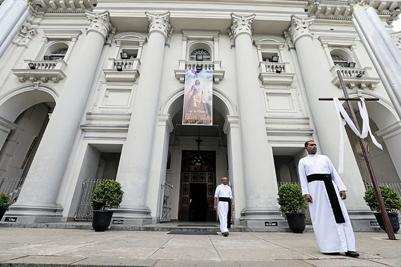 Priests look on at the entrance of St Lucia Cathedral while survivors and families of victims of Sri Lanka's Easter Sunday bombing attacks arrive for a special mass for those who lost their lives, in Colombo, Sri Lanka May 11, 2019. Photo: Reuters