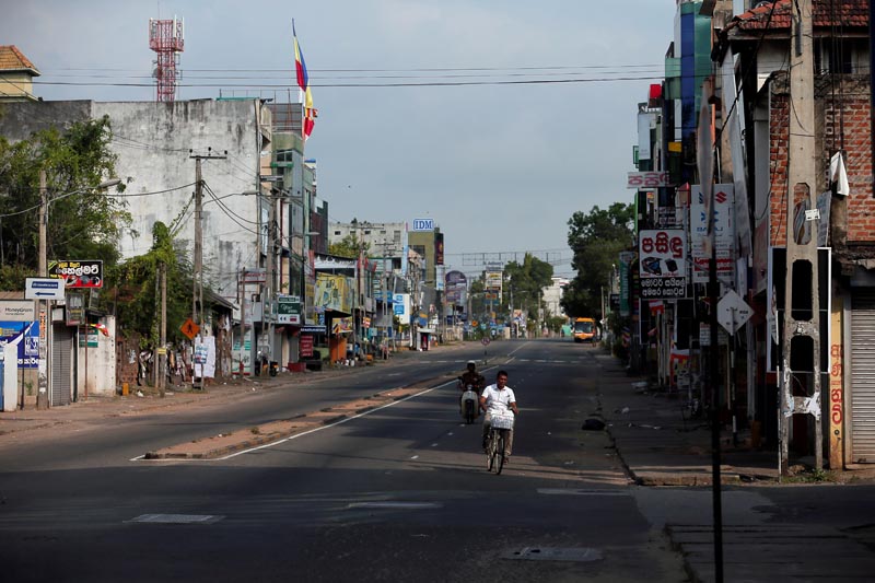 A man rides a bicycle on an empty road during a curfew in Kurunegala, Sri Lanka May 14, 2019. Photo: Reuters