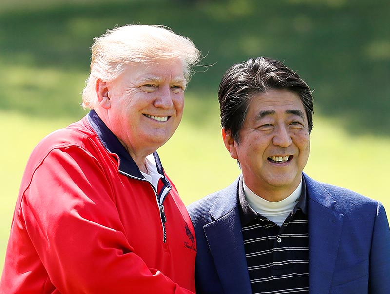 US President Donald Trump and Japanese Prime Minister Shinzo Abe smile on the way to the course to play golf at Mobara Country Club in Mobara, Chiba Prefecture, east of Tokyo, Japan May 26, 2019. Photo: Kimimasa Mayama/Pool via Reuters