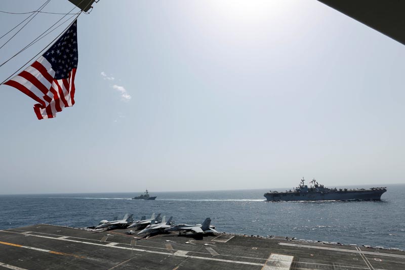 The US Navy Wasp-class amphibious assault ship USS Kearsarge and the Arleigh Burke-class guided-missile destroyer USS Bainbridge sail alongside the Nimitz-class aircraft carrier USS Abraham Lincoln in the Arabian Sea May 17, 2019. Photo: US Navy/Mass Communication Specialist Seaman Michael Singley/Handout via Reuters