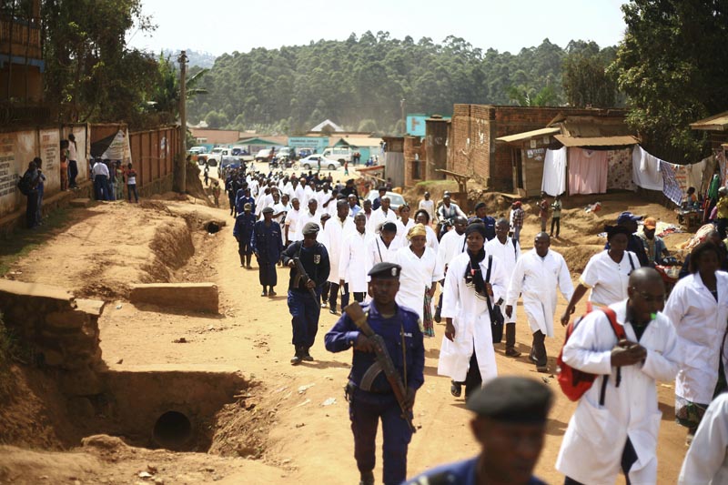 Doctors and health workers march in the Eastern Congo town of Butembo on Wednesday April 24, 2019, after attackers last week shot and killed an epidemiologist from Cameroon who was working for the World Health Organization. Photo: AP