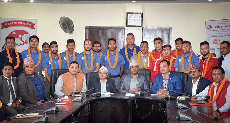 National cricket team members, U-23 footballers and bodybuilder Maheswor Maharjan pose for a photo with Minister for Youth and Sports Jagat Bahadur Sunar (centre) and other officials in Kathmandu on Thursday. Photo: Naresh Shrestha / THT