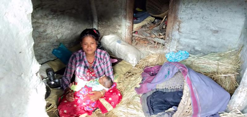 A woman with her newly born child sheltering in a cowshed, in Swami Kartik Khapar Rural Municipality of Bajura district, on Monday, May 13, 2019. Photo: Prakash Singh/THT
