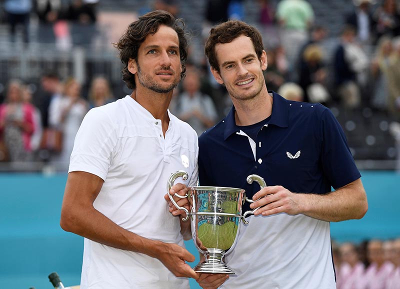 Spain's Feliciano Lopez and Britain's Andy Murray celebrate winning their doubles final match against Rajeev Ram of the US and Britain's Joe Salisbury with the ATP 500 Fever-Tree Championships trophy, at The Queen's Club, in London, Britain, on June 23, 2019. Photo: Action Images via Reuters