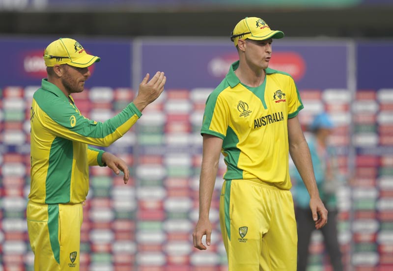 Australia's Jason Behrendorff (right) is asked by Australia's captain Aaron Finch to lead the team off the field after the end of Cricket World Cup match between England and Australia at Lord's cricket ground in London, Tuesday, June 25, 2019. Photo: AP