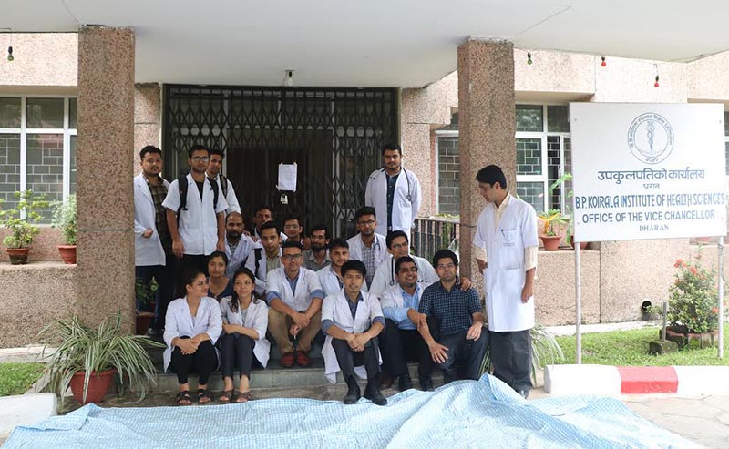 Residential doctors staging a sit-in after they padlocked the office of the vice-chancellor and rector at BP Koirala Institute of Health Sciences, in Sunsari, on Thursday, June 27, 2019. Photo: THT