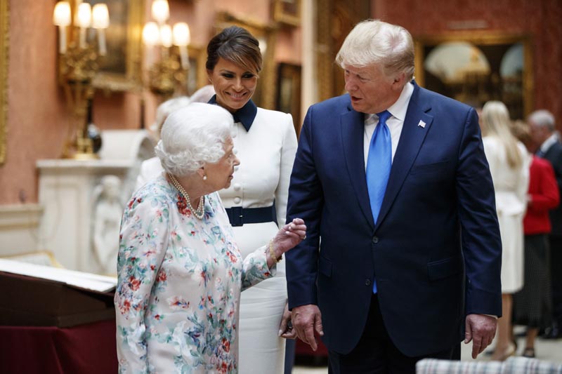 Britain's Queen Elizabeth II speaks to US President Donald Trump, right and first lady Melania as they view US memorabilia from the Royal Collection, at Buckingham Palace, London, Monday, June 3, 2019. Photo: Tolga Akmen/Pool Photo via AP