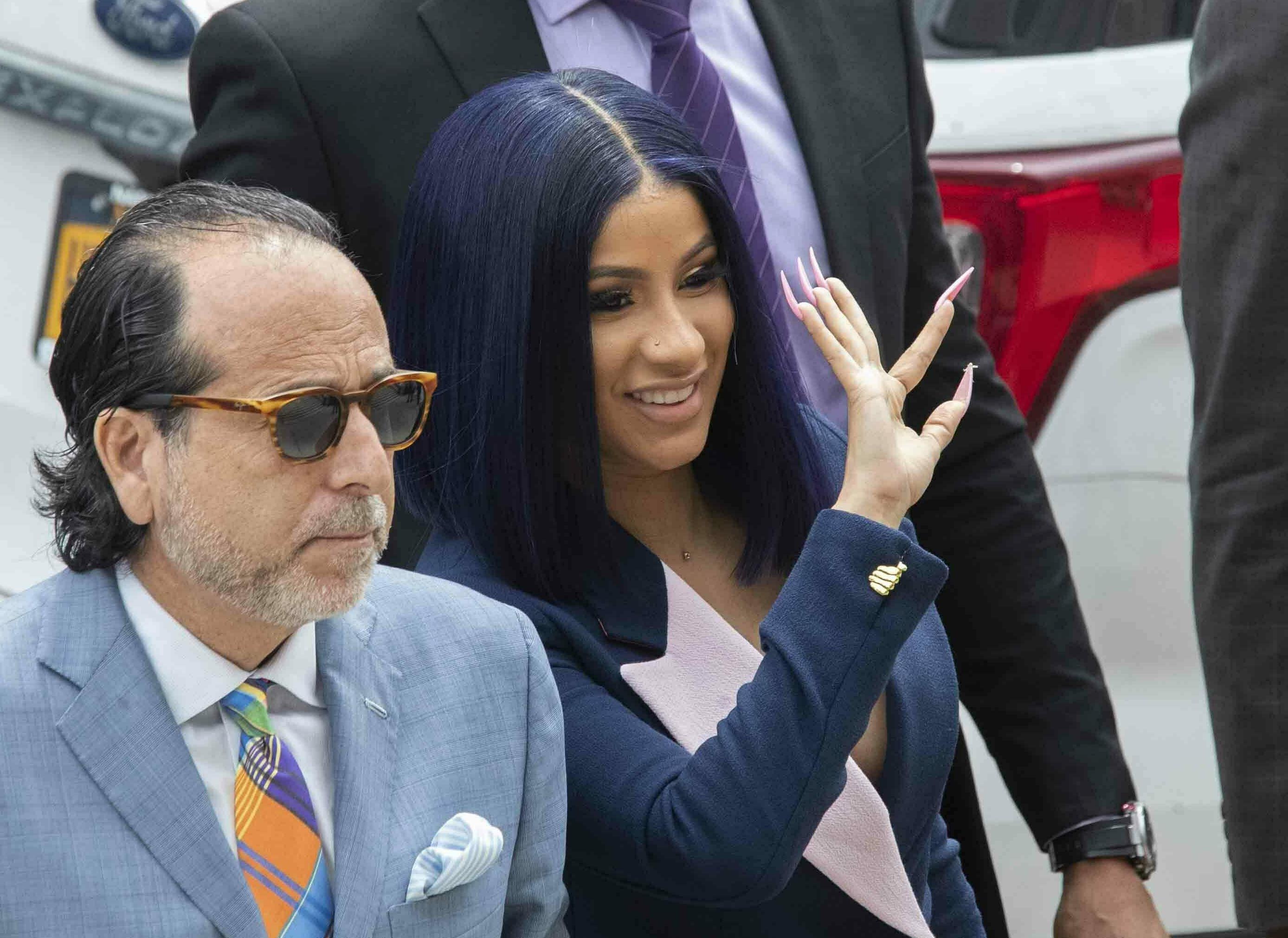 Grammy-winning rapper Cardi B, right, waves at fans as she arrives for a hearing at Queens County Criminal Court, Tuesday, June 25, 2019, in New York. Photo: AP