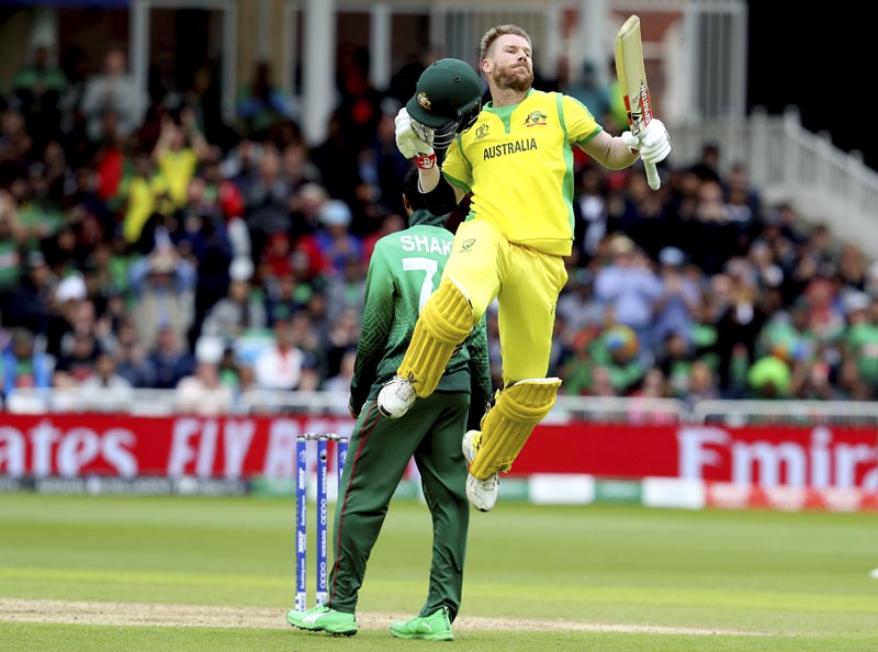 Australia's David Warner leaps in the air to celebrate scoring a century during the Cricket World Cup match between Australia and Bangladesh at Trent Bridge in Nottingham, Thursday, June 20, 2019. Photo: AP