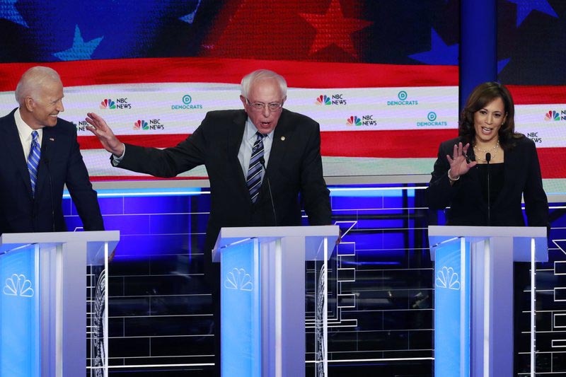 Democratic presidential candidate Senator Bernie Sanders, I-Vt., center, gestures towards former vice president Joe Biden, as Sen. Kamala Harris, D-Calif., talks, during the Democratic primary debate hosted by NBC News at the Adrienne Arsht Center for the Performing Art, Thursday, June 27, 2019, in Miami. Photo: AP
