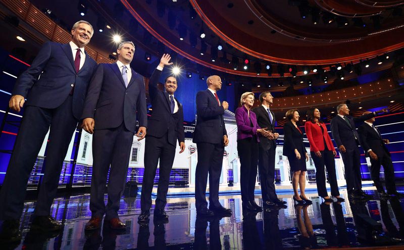 From left, New York City Mayor Bill de Blasio, Rep. Tim Ryan, D-Ohio, former Housing and Urban Development Secretary Julian Castro, Sen. Cory Booker, D-N.J., Sen. Elizabeth Warren, D-Mass., former Texas Rep. Beto Ou0092Rourke, Sen. Amy Klobuchar, D-Minn., Rep. Tulsi Gabbard, D-Hawaii, Washington Gov. Jay Inslee, and former Maryland Rep. John Delaney pose for a photo on stage before the start of a Democratic primary debate hosted by NBC News at the Adrienne Arsht Center for the Performing Arts, Wednesday, June 26, 2019, in Miami. Photo: AP