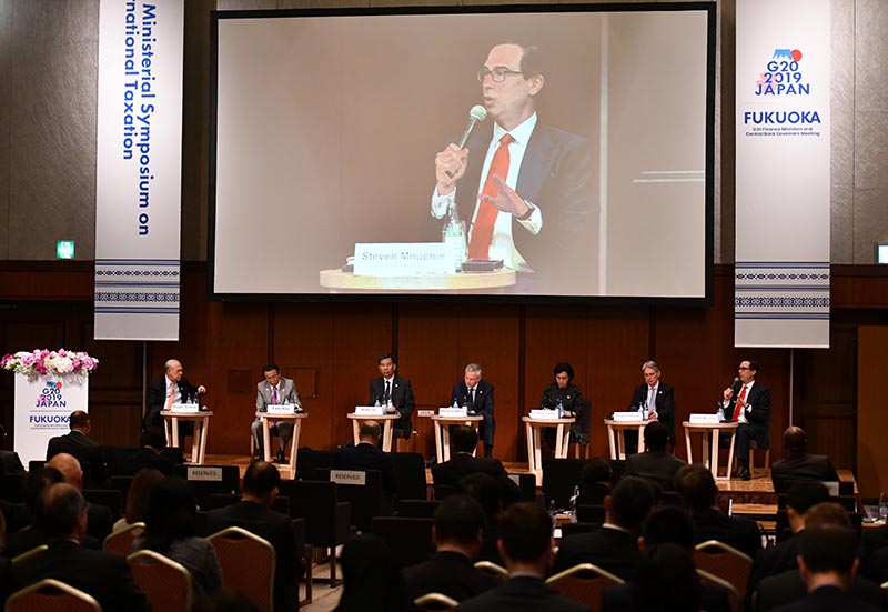 US Secretary of Treasury Steven Mnuchin (R, on podium) delivers a speech during the G20 Ministerial Symposium on International Taxation in the G20 Finance Ministers and Central Bank Governors meeting in Fukuoka on June 8, 2019. Photo: Toshifumi Kitamura/Pool via Reuters