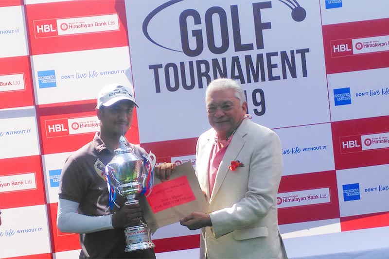 Himalayan Bank Amex Golf Tournament winner Rishav Raj Acharya (left) receives the trophy from Himalayan Bank Ltd Chairman Manoj Bahadur Shrestha at the Royal Nepal Golf Club on Saturday, June 8, 2019. Photo courtesy: RNGC