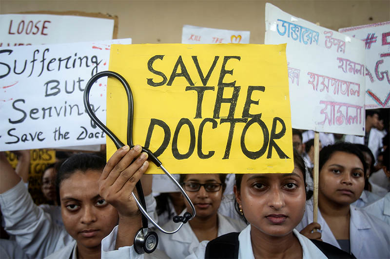 A doctor holds a placard at a government hospital during a strike demanding security after the recent assaults on doctors by the patients' relatives, in Agartala, India, June 14, 2019. Photo: Reuters