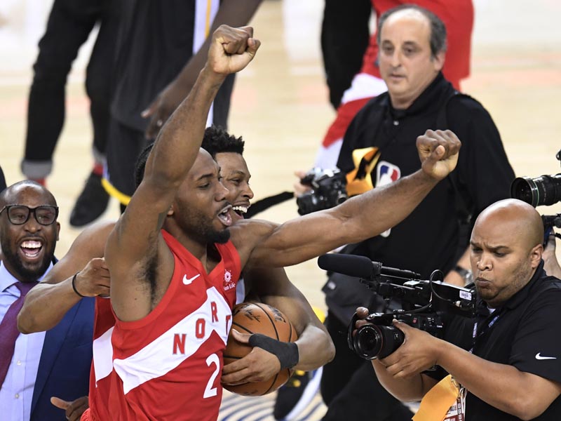 Toronto Raptors forward Kawhi Leonard (2) and guard Kyle Lowry (back) celebrate after the Raptors defeated the Golden State Warriors 114-110 in Game 6 of basketballu0092s NBA Finals, Thursday, June 13, 2019, in Oakland, California. Photo: Frank Gunn/The Canadian Press via AP