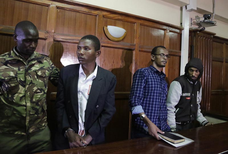 From left to right, defendants Rashid Charles Mberesero, Hassan Aden Hassan and Mohamed Abdi Abikar, are led from the dock by a police officer (left) after their verdict at a court in Nairobi, Kenya Wednesday, June 19, 2019. Photo: AP