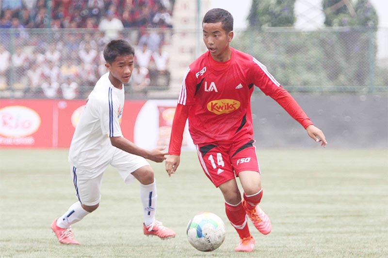 A player of Little Angels School (right) dribbles the ball against Shree Krishna Secondary School player during their Kwiks Cup Inter-school Football Tournament at the ANFA Complex, Satdobato in Lalitpur on Friday, June 28, 2019. Photo: Udipt Singh Chhetry/THT