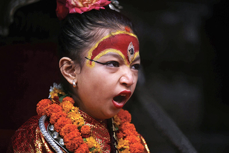 Nepal's Living Goddess Kumari yawns as she observes the Rato Machhindranath chariot festival, in Lalitpur, on Thursday, June 06, 2019. Photo: Skanda Gautam/ THT