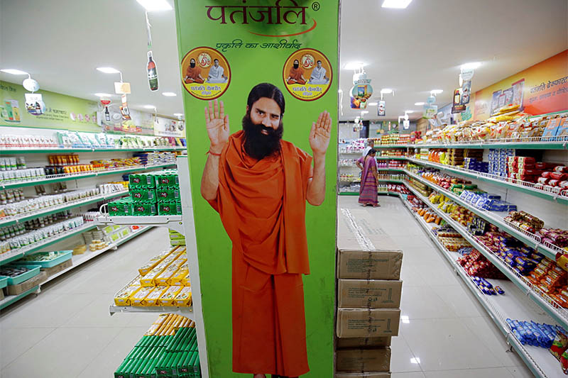 A hoarding with an image of Baba Ramdev is seen inside a Patanjali store in Ahmedabad, India, March 28, 2019. Picture taken March 28, 2019. Photo: Reuters