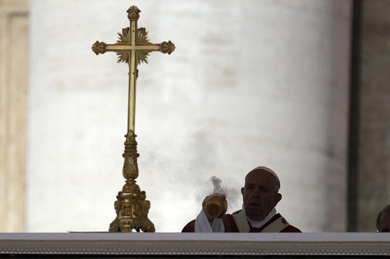Pope Francis is silhouetted as he spreads incense on the altar during a Pentecost Mass in St. Peter's Square, at the Vatican, Sunday, June 9, 2019. Photo: AP