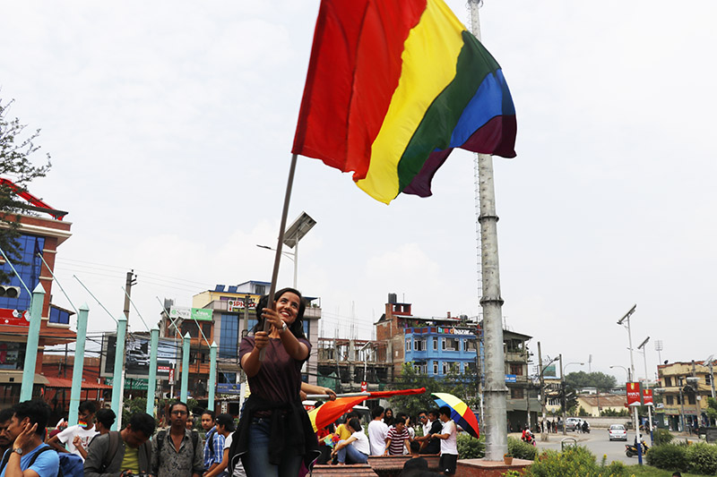 A participant waves the rainbow flag with joy while taking part in Nepal's first pride parade during the pride month, in Kathmandu, on Saturday, June 29, 2019. Photo: Ankit Khadgi/THT
