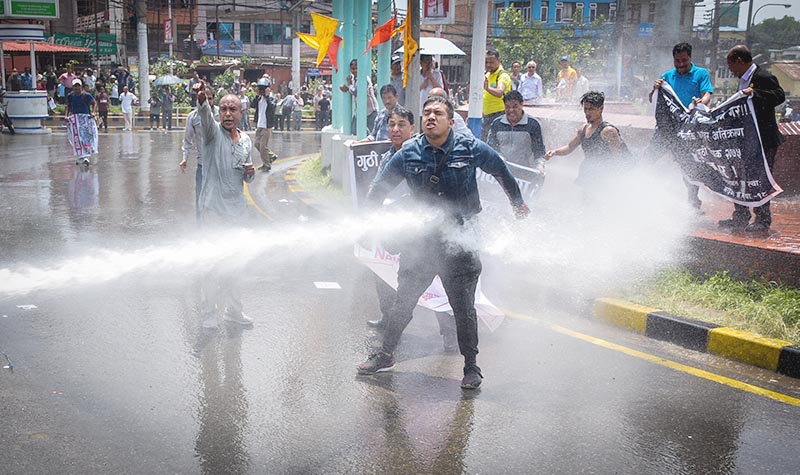 Cops using water cannon to disperse demonstrators protesting the Guthi Bill registered in the National Assembly, in Kathmandu, on Sunday, June 9, 2019. Photo: Naresh Krishna Shrestha/THT