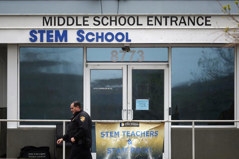 FILE - In this Wednesday, May 8, 2019, file photo, a Douglas County, Colorado, Sheriff's Department deputy walks past the doors to the STEM School Highlands Ranch, in Highlands Ranch, Colorado. Photo: AP