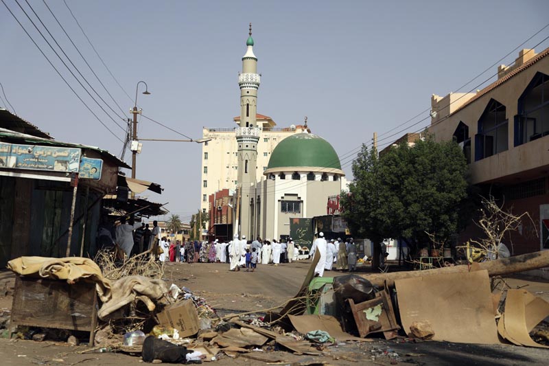 Worshippers gather at a mosque behind a roadblock set by protesters on a main street in the Sudanese capital Khartoum to stop military vehicles from driving through the area on Wednesday, June 5, 2019. Photo: AP