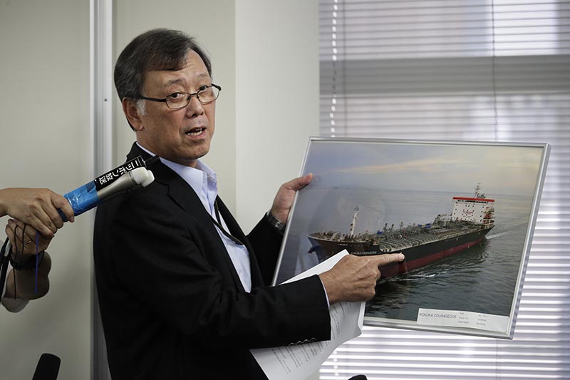 Yutaka Katada, president of Kokuka Sangyo Co, the Japanese company operating one of two oil tankers attacked near the Strait of Hormuz, shows a photo of the attacked oil tanker during a news conference Friday, June 14, 2019, in Tokyo. Photo: AP
