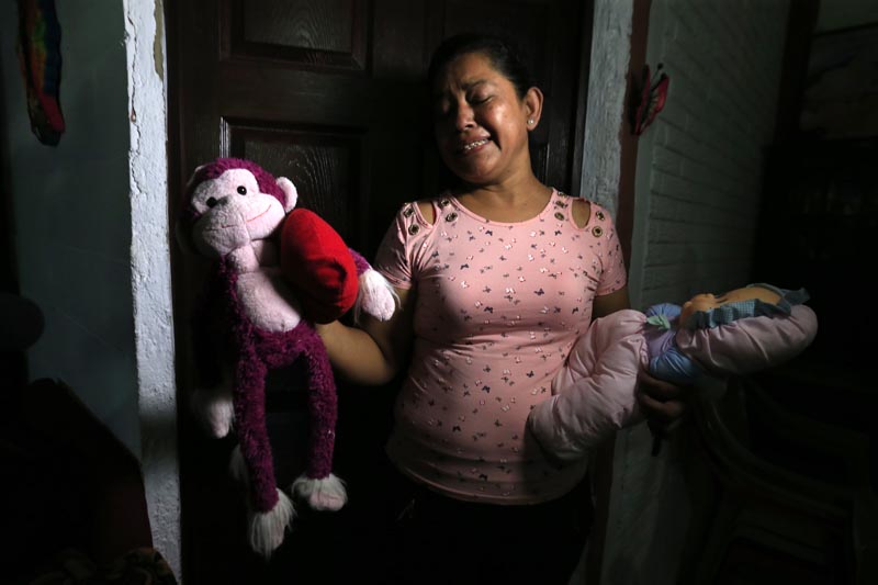 Rosa Ramirez sobs as she shows journalists toys that belonged to her nearly 2-year-old granddaughter Valeria in her home in San Martin, El Salvador, Tuesday, June 25, 2019. Photo: AP