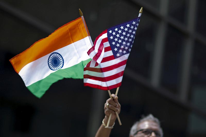 FILE: A man holds the flags of India and the US while people take part in the 35th India Day Parade in New York August 16, 2015. Photo: Reuters