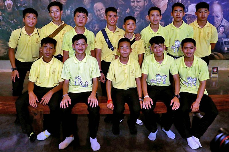 Members of the Wild Boars soccer team pose for a photo during their return to the Tham Luang caves, where they were trapped in a year ago, in Chiang Rai, Thailand, June 24, 2019. Photo: Reuters