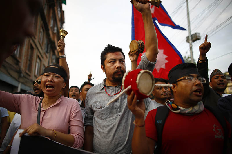 Members of Newar community taking part in a symbolic protest against the controversial Guthi bill outside the mayoru2019s residence, in Kathmandu, on Saturday. Protesters demanded withdrawal of the bill registered in the National Assembly. Photo: Skanda Gautam/THT