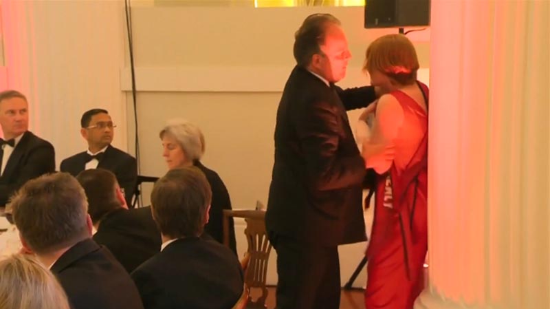 A junior foreign office minister Mark Field grapples with one of the women demonstrator and holds her by the back of her neck as he marched her out of the room, in London's landmark Mansion House building, on Thursday, June 21, 2019. Photo: videograb of Reuters video