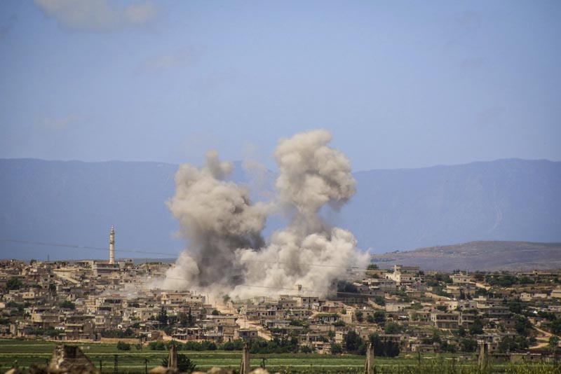 FILE: In this May 3, 2019 file photo, provided by the Syrian Civil Defense White Helmets, which has been authenticated based on its contents and other AP reporting, shows smoke rising after Syrian government and Russian airstrikes that hit the town of al-Habeet, southern Idlib, Syria. Photo: Syrian Civil Defense White Helmets via AP/ File