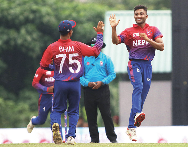 Nepal's Sagar Dhakal (right) celebrates with Bhim Sarki after taking a wicket against China during their ACC U-19 Eastern Region cricket tournament match at the Kinrara Oval in Kuala Lumpur, Malaysia on Wednesday. Photo Courtesy: CricketingNepal