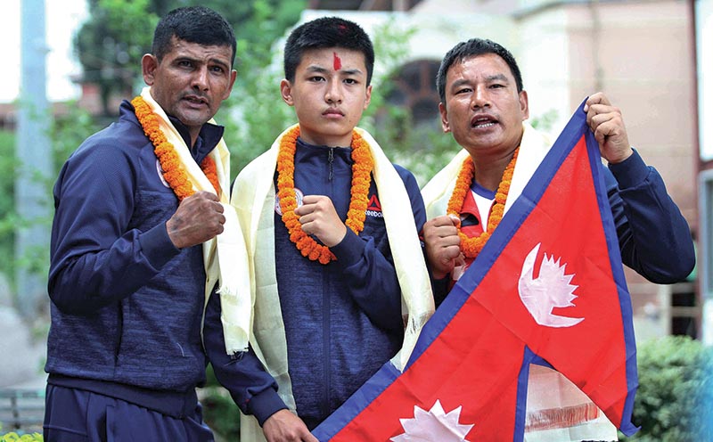 A player and officials of boxing take group photo with national flag during their farewell to particiapte in the ASBC (Asian Boxing Confederation) School Boxing Championship in Kuwait at National Sports Council in Kathmandu on Monday. Photo: THT