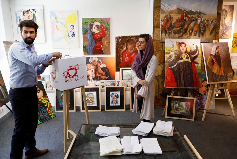 A member of the ArtLords opens the letters box of Dard-e-Dil (a painful heart) project in Kabul, Afghanistan July 6, 2019. Photo: Reuters