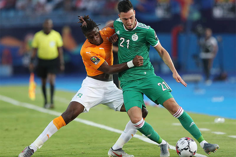 Algeria's Ramy Bensebaini in action with Ivory Coast's Wilfried Zaha. Photo: Reuters