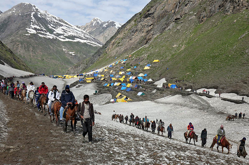 Hindu pilgrims trek through mountains to reach the Amarnath cave shrine where they worship an ice stalagmite that Hindus believe to be the symbol of Lord Shiva, at Sangam Top in the Kashmir region, July 07, 2019. Photo: Reuters