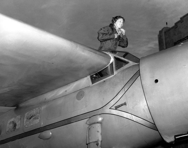 American aviatrix Amelia Earhart climbs from the cockpit of her plane at Los Angeles, California, after a flight from Oakland to visit her mother, January 13, 1935. Photo: AP/File